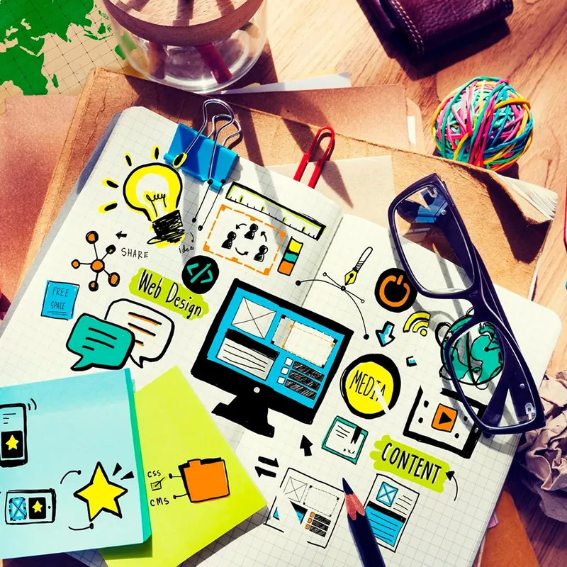 Website wireframes and UI sketches in a notebook